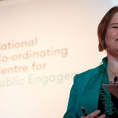 Sophie Duncan presenting at an Engage Conference with NCCPE logo in the background