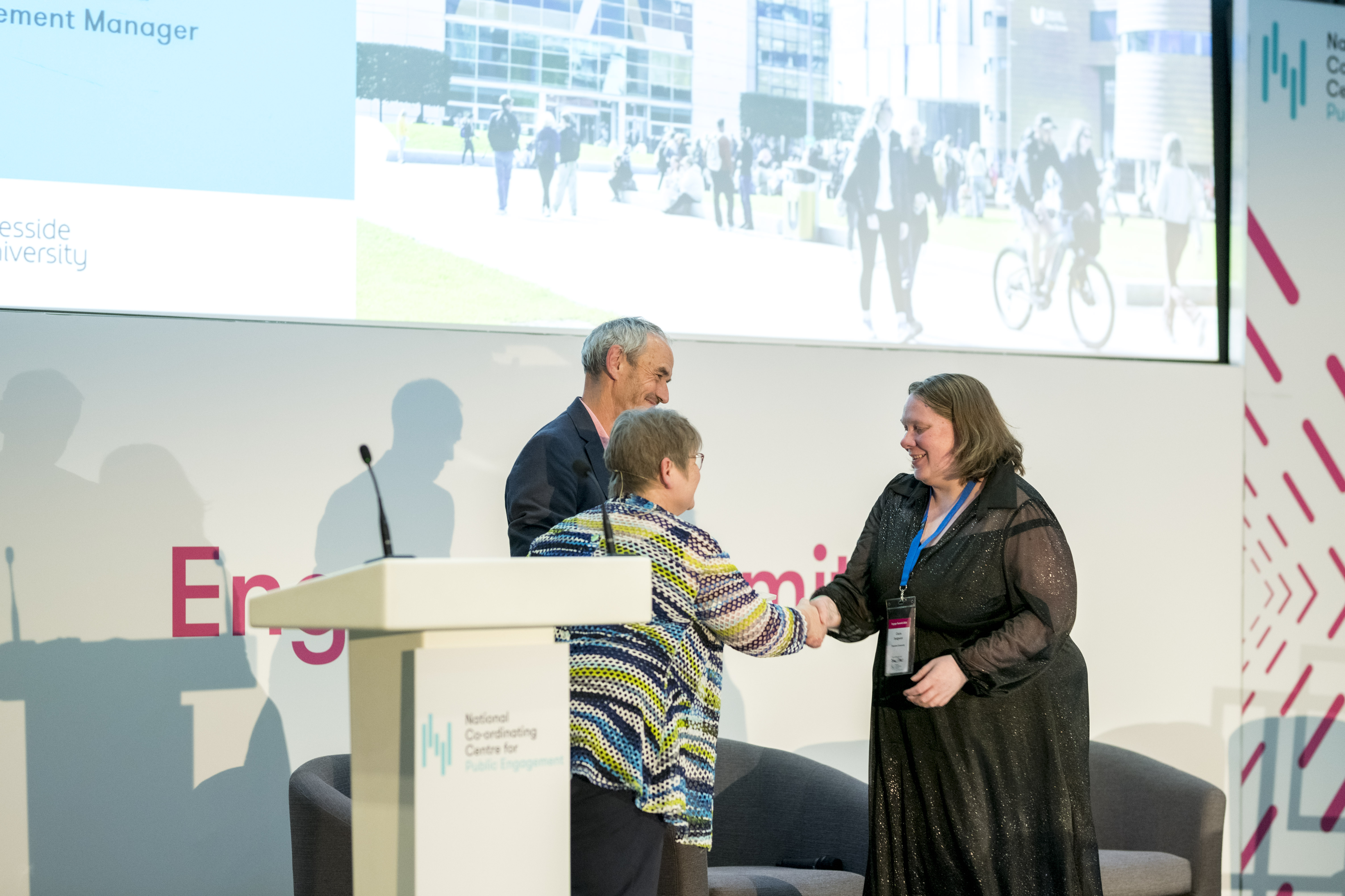 woman receiving award on stage at Engage 2026