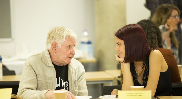 Elderly man talking to a young woman