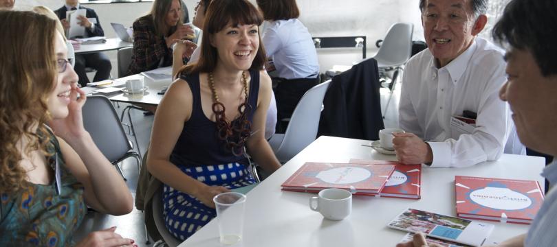 man and two women laughing and talking together