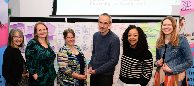 Ann, Zoe, Sophie, Paul, Gemma and Asphodel standing together and smiling at the NCIA action learning event