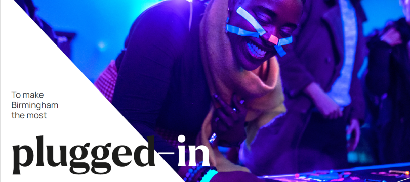 Poster from Birmingham's public engagement stragegy: photo of a person taking part in an activity with lights, with text saying: Our vision: to make Birmingham the most plugged-in university in the world.
