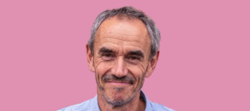 Photo of Paul Manners in a blue shirt smiling at the camera