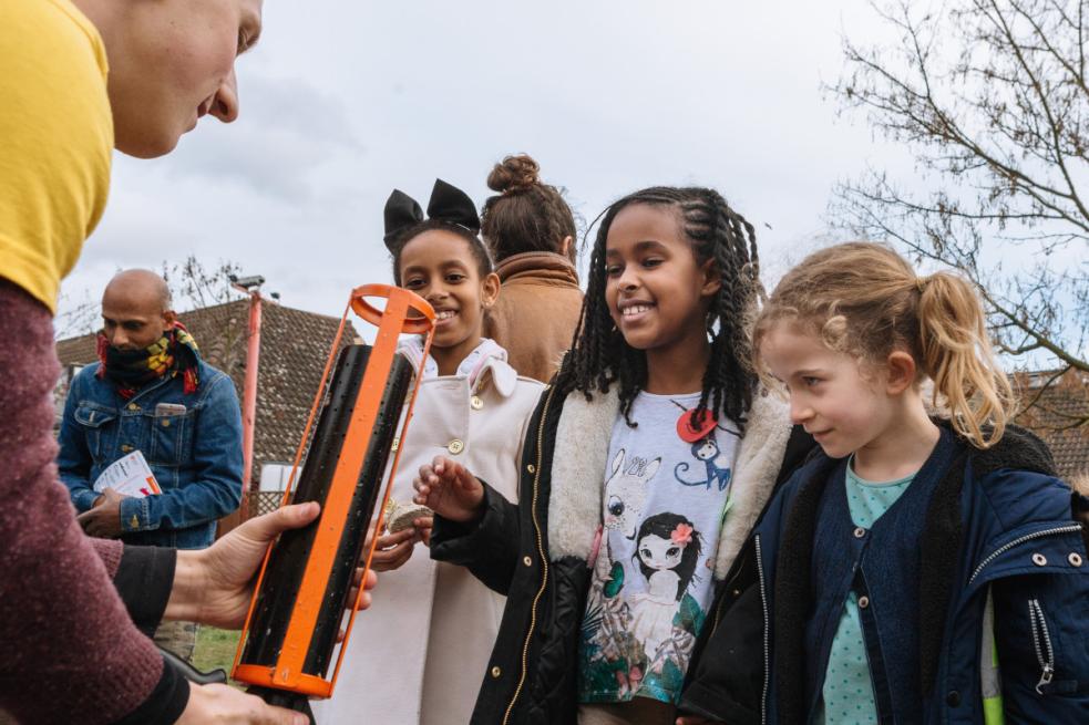 Three girls looking at a demonstration