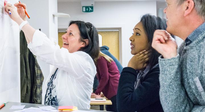 Excited colleagues look at a board