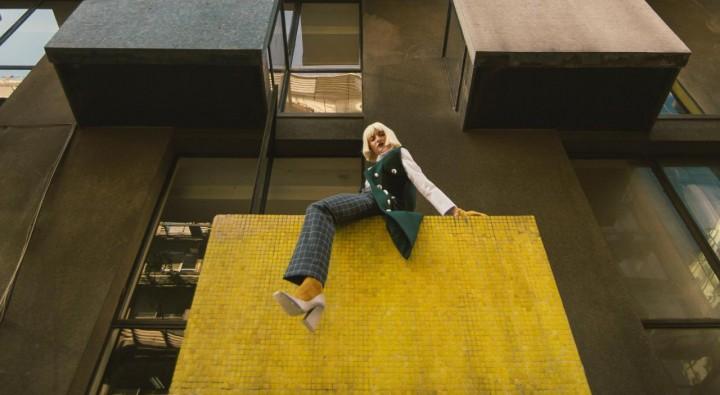 Woman on a building balcony 2