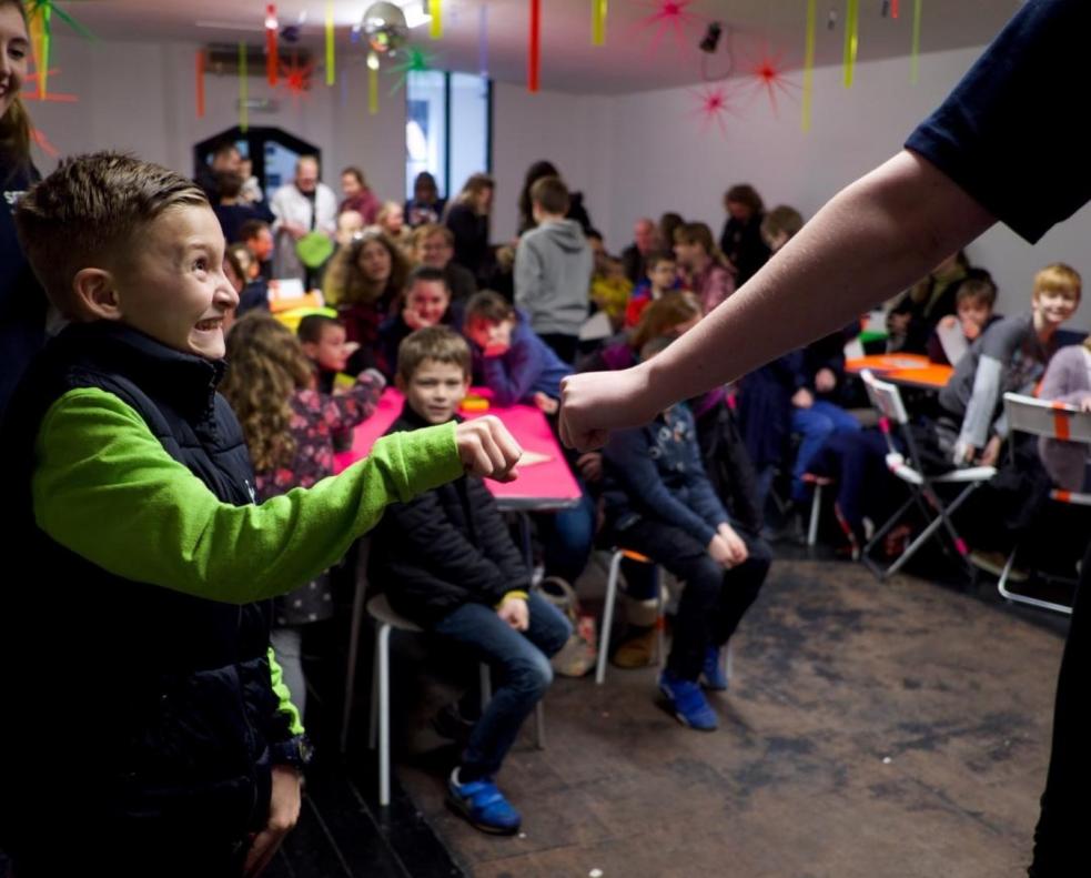 Young person fist-bumping adult