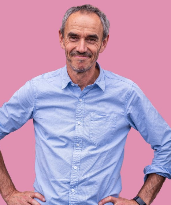 Photo of Paul Manners in a blue shirt smiling at the camera