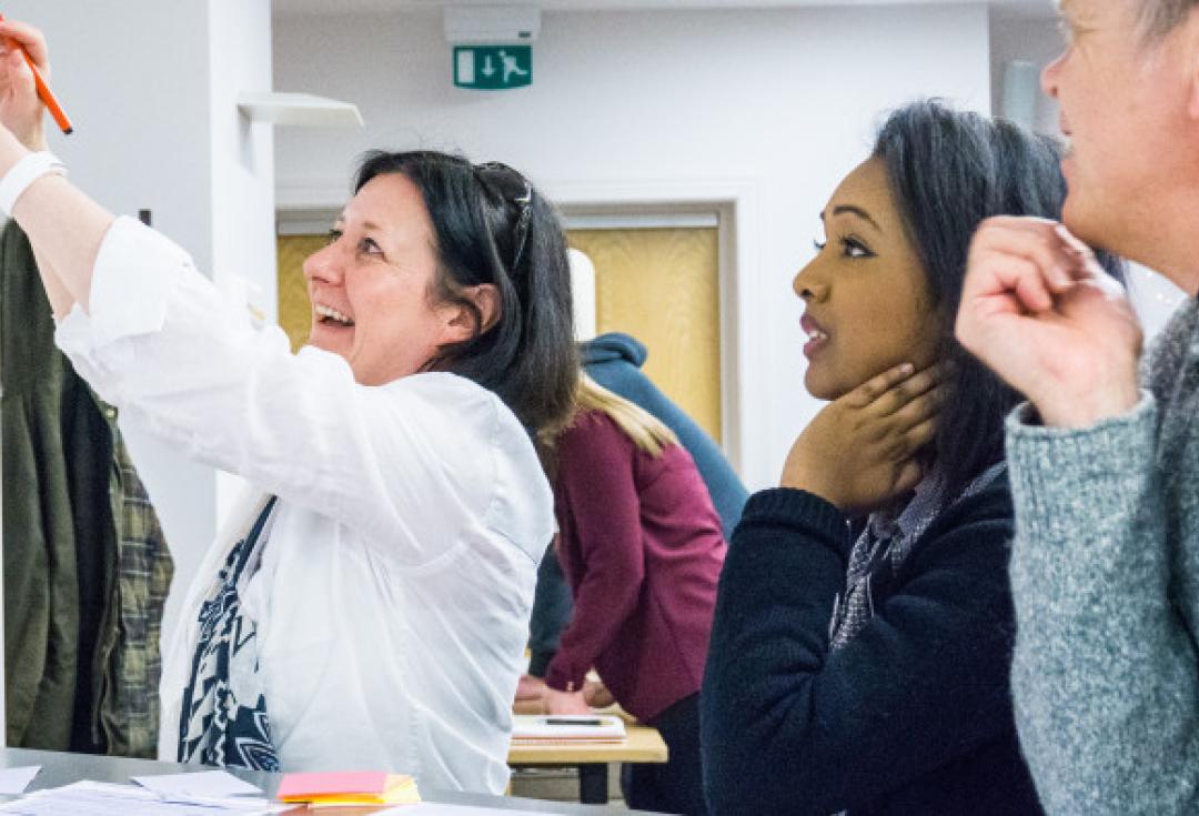 Excited colleagues look at a board