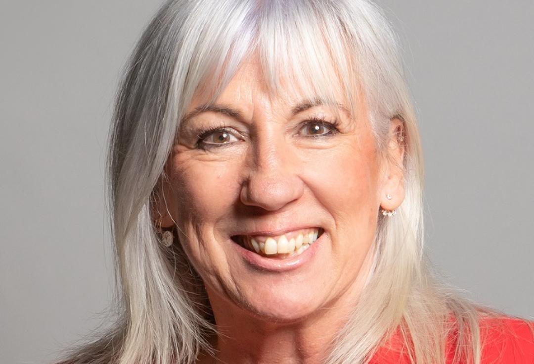 A portrait of Amanda Solloway, smiling at the camera