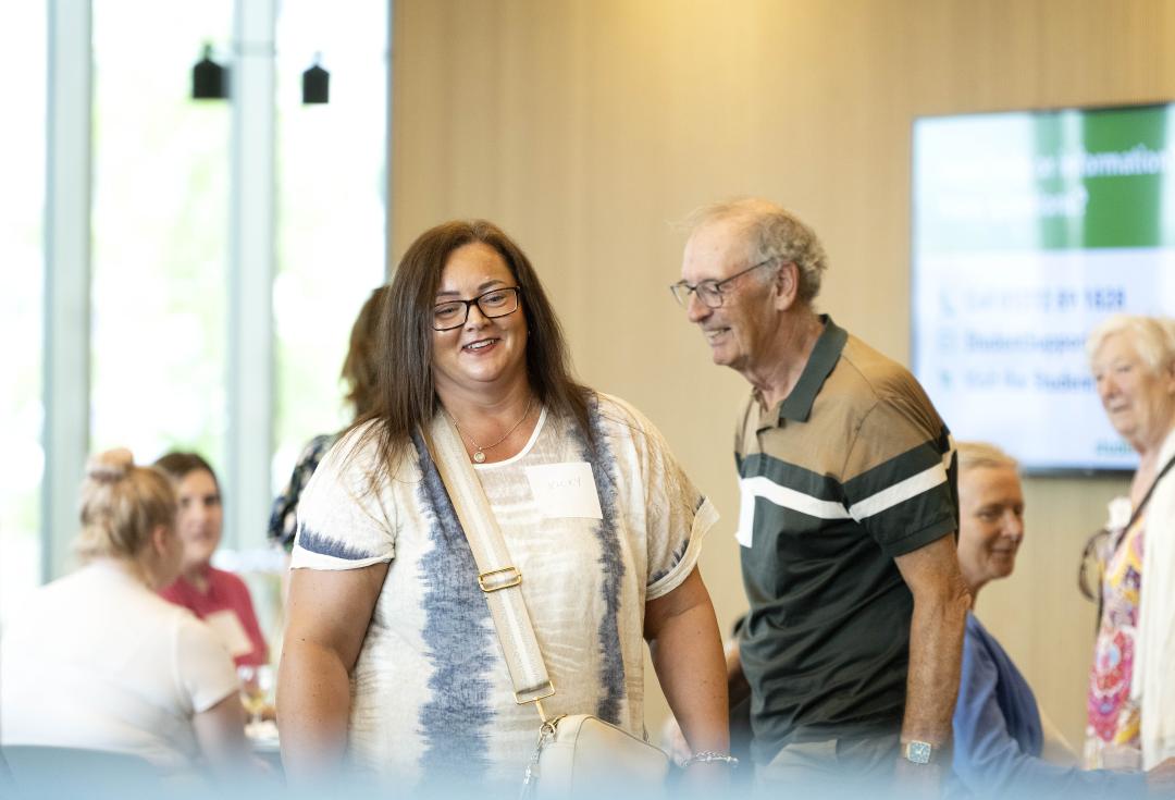 People smiling, taking part in a Community Action Forum event 