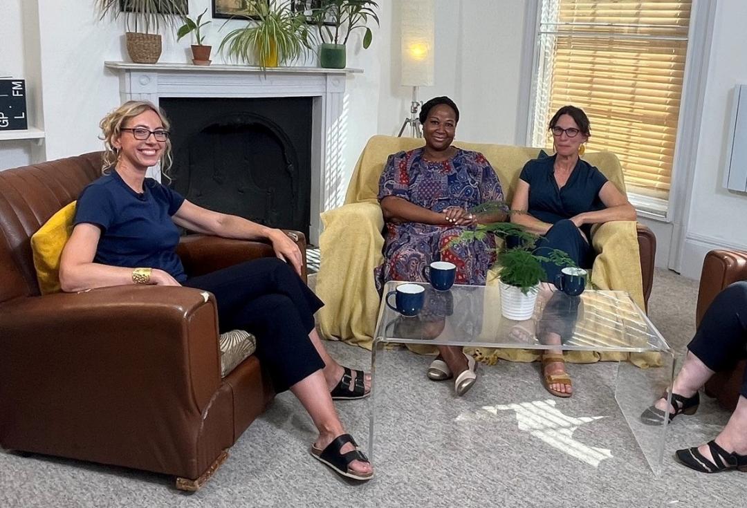 Sophie Duncan, Jude Fransman, Fay Scott, Louise Archer (R-L) sat in armchairs around a coffee table, with filming and sound equipment around them, smiling at the camera