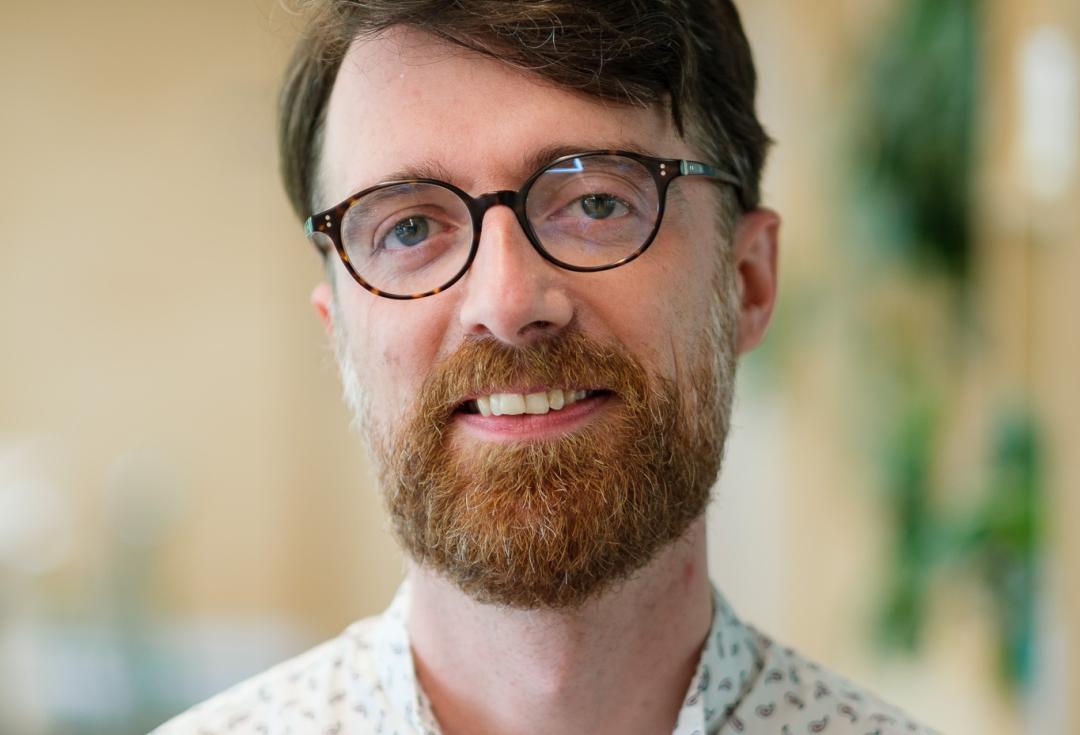 Headshot of a man smiling at the camera