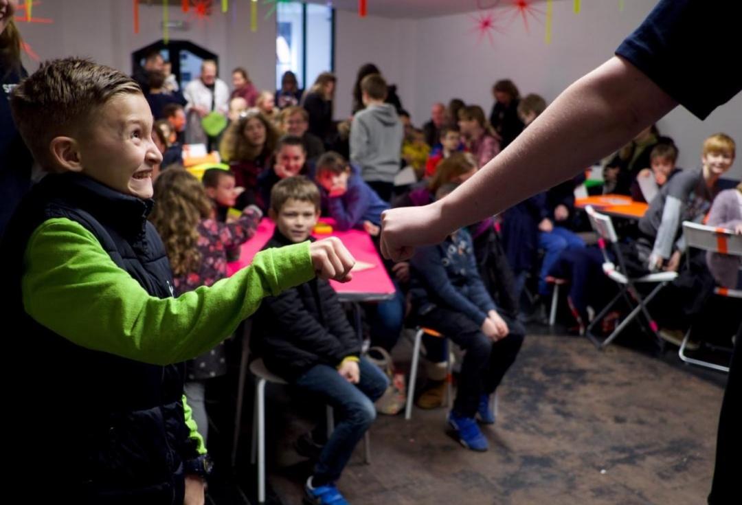 Young person fist-bumping adult