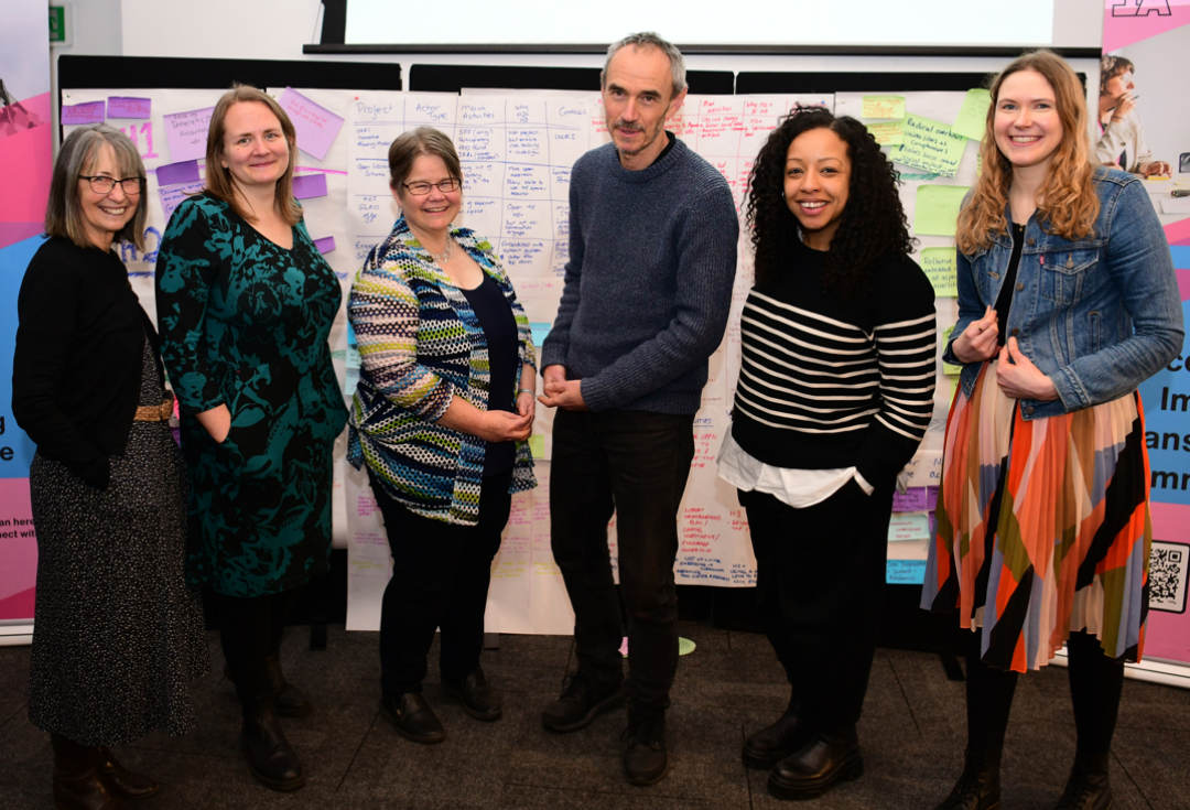 Ann, Zoe, Sophie, Paul, Gemma and Asphodel standing together and smiling at the NCIA action learning event