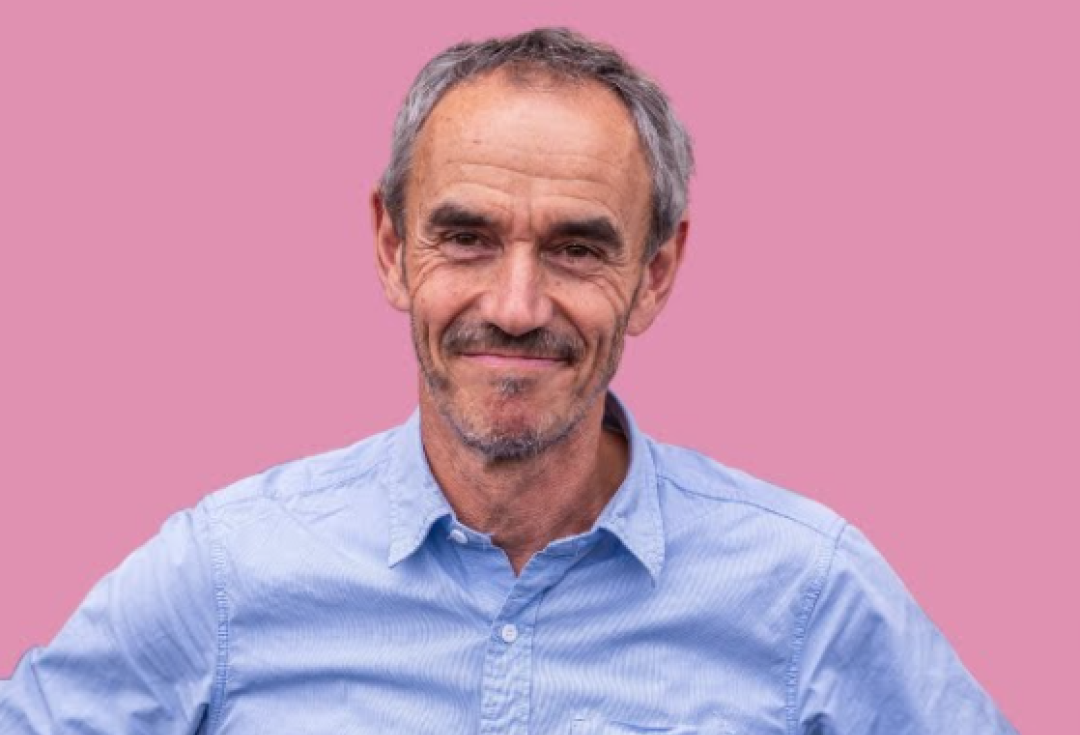 Photo of Paul Manners in a blue shirt smiling at the camera