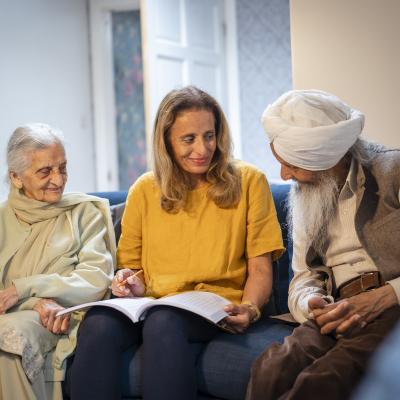 group of women and men of south asian origin sitting and talking 