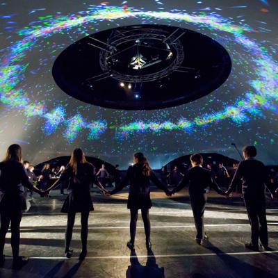 People standing in a ring holding hands in the danceroom Spectroscopy