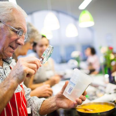 Man reading a label with magnifying glass