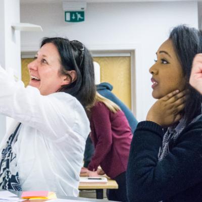 Excited colleagues look at a board