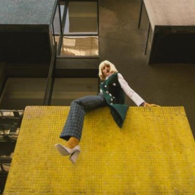 Woman on a building balcony 2