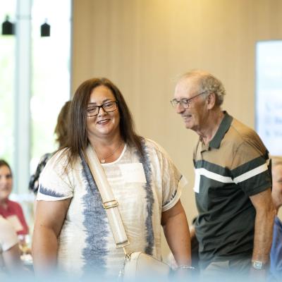 People smiling, taking part in a Community Action Forum event 