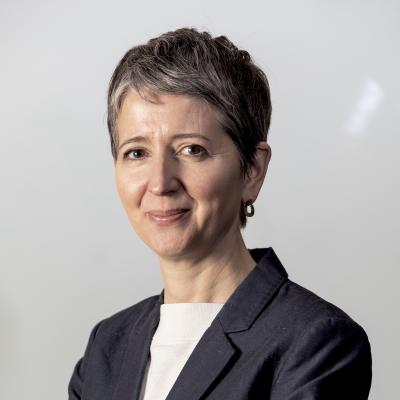 Headshot of Christina Boswell smiling wearing a suit jacket against a plain background