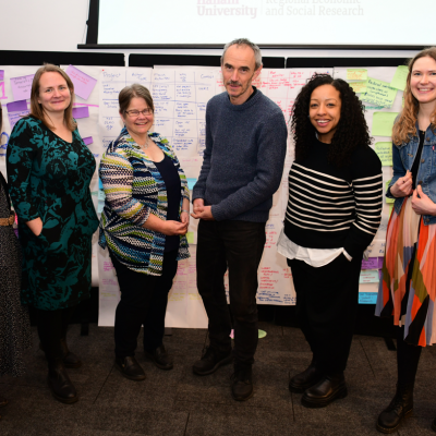 Ann, Zoe, Sophie, Paul, Gemma and Asphodel standing together and smiling at the NCIA action learning event
