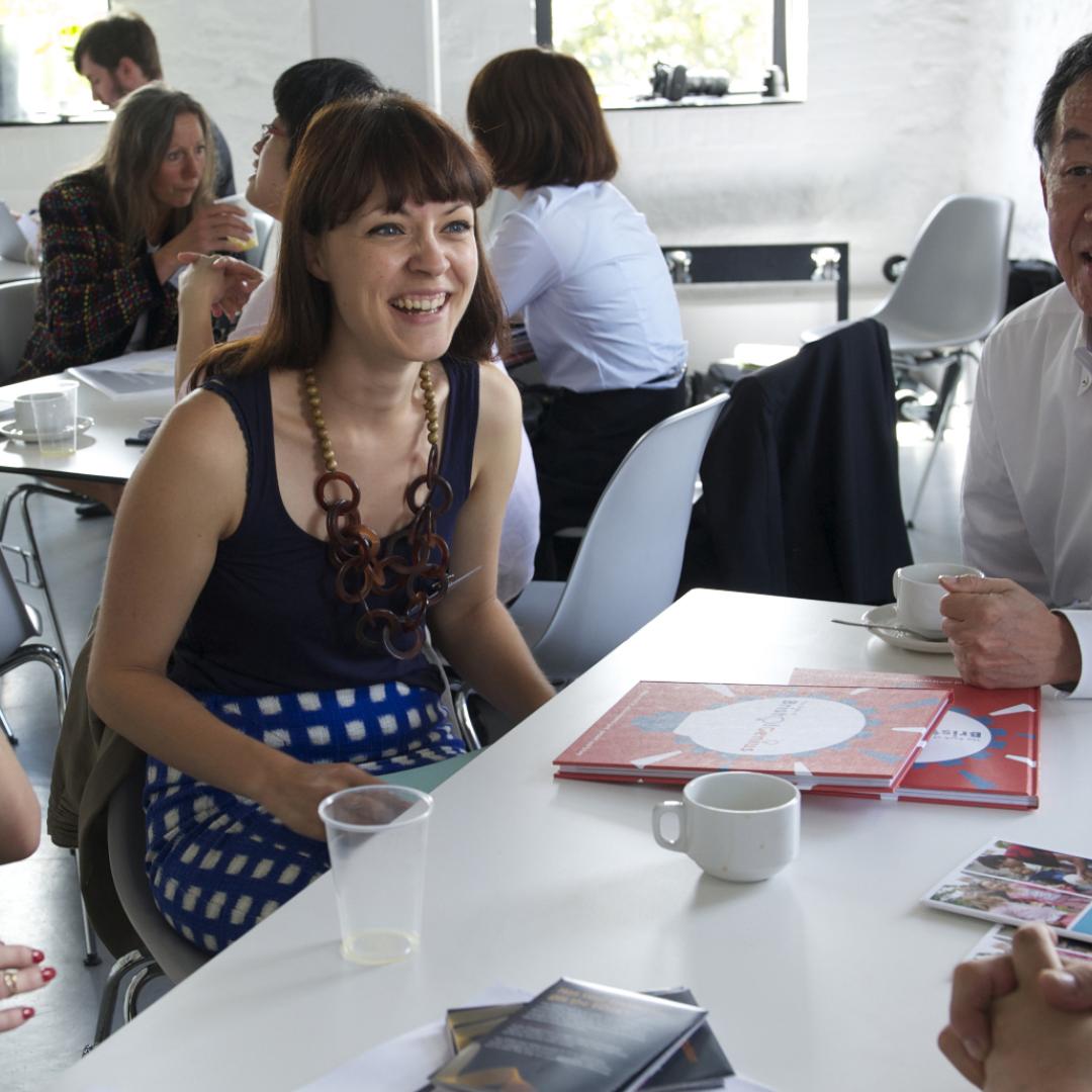 man and two women laughing and talking together